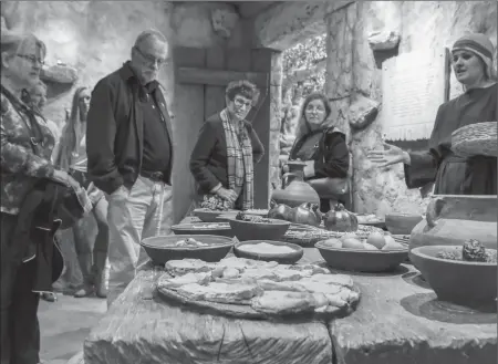  ?? Bill O’Leary/Washington Post ?? Visitors listening to a "living history interprete­r," right, in a setting made to look like ancient Jerusalem.