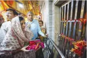  ?? — PTI ?? Delhi CM Arvind Kejriwal’s wife Sunita Kejriwal offers prayers at the Hanuman Mandir in Connaught Place in New Delhi on Tuesday.