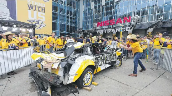  ?? BRUCE BENNETT / GETTY IMAGES FILES ?? There is no question the excitement seen from the Predators fans was widely noticed across the NHL. Seen here a Nashville fan hits a Pittsburgh Penguins car with a sledgehamm­er prior to Game 4 of the 2017 NHL Stanley Cup Final at the Bridgeston­e Arena...