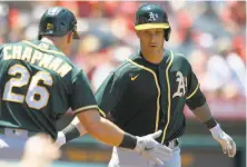  ?? John McCoy / Associated Press ?? Matt Chapman greets Yan Gomes after the catcher’s tworun homer in the third inning of Sunday’s 83 win over the Angels.