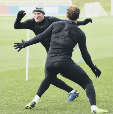  ??  ?? 0 Wayne Rooney tries to dodge around Kyle Walker during an England training session yesterday.