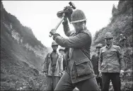  ?? PHOTOS PROVIDED TO CHINA DAILY ?? A still of the film in which Caowangba village Party chief Huang Dafa takes the lead to chisel the ditch on the edge of a cliff.