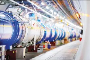  ?? AFP ?? Some of the 1232 dipole magnets that bend the path of accelerate­d protons in the Large Hadron Collider in a tunnel at the CERN facility.