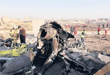  ?? NOROOZI/AP2020 EBRAHIM ?? Wreckage from the downed airliner covers a field where Ukraine Internatio­nal Airlines Flight PS752 crashed southwest of Tehran, Iran.