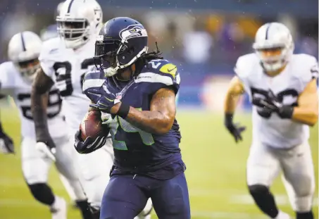  ?? Stephen Brashear / Associated Press 2014 ?? Marshawn Lynch made his mark for the Seahawks, who made an exchange of 2018 draft picks with Oakland for his rights.