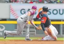  ?? Scott Cunningham, Getty Images ?? Rockies shortstop Trevor Story tags the Braves’ Freddie Freeman for a first-inning out Sunday in Atlanta. Freeman, who reached on a walk, was trying to steal second base.