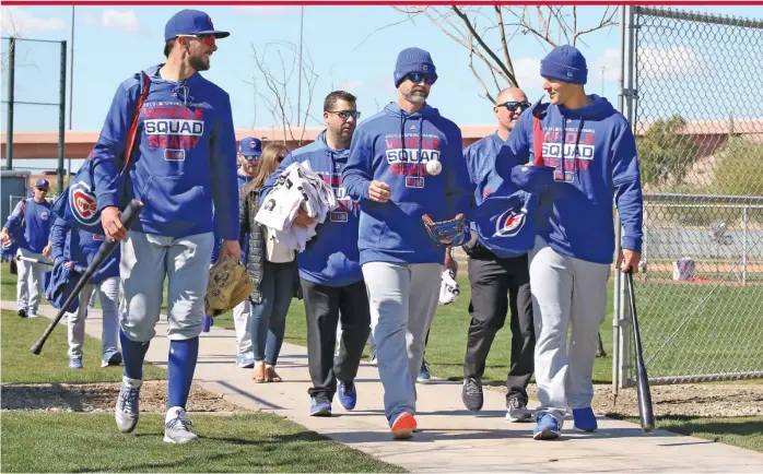  ?? JOHN ANTONOFF/FOR THE SUN-TIMES ?? David Ross (flanked by Kris Bryant and Anthony Rizzo during spring training in 2019), who will replace Joe Maddon, has not been a manager at any level and has no coaching experience.