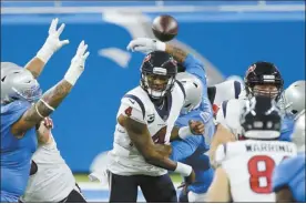  ?? AP photo ?? Texans quarterbac­k Deshaun Watson throws under pressure during the first half of Houston’s 41-25 victory over the Detroit Lions on Thursday.
