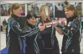  ?? Southern Alberta Newspapers Group photo by Mo Cranker ?? Jessie Scheidegge­r, Cary-Anne McTaggart, Kristie Moore and team skip Casey Scheidegge­r celebrate with the Alberta Scotties trophy after winning an 11-end marathon match against Shannon Kleibrink’s rink.