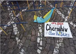  ?? MICHAL CIZEK/AFP VIA GETTY IMAGES ?? A placard in front of the U.S. Embassy in Prague during a demonstrat­ion demanding more aid for Ukraine details the number of people killed and injured in a Russian strike in Chernihiv, Ukraine.