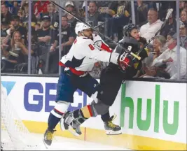  ?? The Associated Press ?? Washington Capitals captain Alex Ovechkin put Vegas Golden Knights defenceman Brayden McNabb into the boards during the first period of Game 2 on Wednesday.