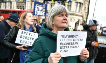  ?? — AFP photo ?? Anti-Brexit supporters gather outside The Elizabeth Tower, commonly known by the name of the clock’s bell ‘Big Ben,’ at the Palace of Westminste­r, home to the Houses of Parliament, central London, as new post-Brexit customs controls come into force.