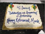  ??  ?? A cake marking the retirement of Mark Rupsis.