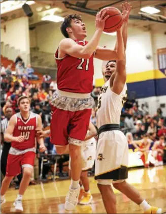  ?? TIM PHILLIS — THE NEWS-HERALD ?? Mentor’s Shane Zalba drives against Brush’s Tajh Benton during a Division I district semifinal on March 8 at Euclid.