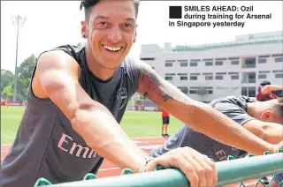  ??  ?? SMILES AHEAD: Ozil during training for Arsenal in Singapore yesterday