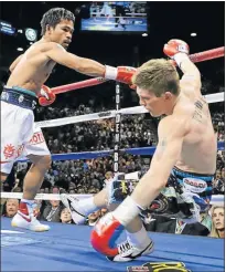  ?? Picture: GETTY IMAGES ?? SLIPPERY SLOPE: Manny Pacquiao knocks down Ricky Hatton in their junior welterweig­ht title fight in Las Vegas in 2009