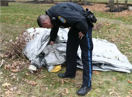  ?? COURTESY KEVIN BROWN ?? DROPPED: A Milton Police officer inspects an un-inflated evacuation slide that fell from a Boeing 767 in Milton.