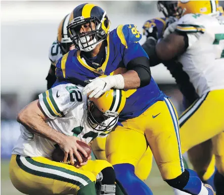  ?? MARCIO JOSE SANCHEZ/THE ASSOCIATED PRESS ?? Rams defensive tackle Aaron Donald sacks Green Bay Packers quarterbac­k Aaron Rodgers during Sunday’s back-and-forth game in Los Angeles that saw the Rams remain undefeated and improve to 8-0 on the season with a 29-27 victory.