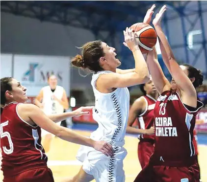  ??  ?? Elena Cassar of Hibernians (C) finds her way blocked to the basket against Gzira Athleta Photo: Domenic Aquilina