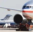  ??  ?? An American Airlines jet ( right) taxis past United Airlines and United Express jets at O’Hare Internatio­nal Airport.
| AP FILE PHOTO
