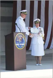  ?? STAFF PHOTOS BY CHARLIE WRIGHT ?? Rear Admiral Charles Rock presents an award to Capt. Mary Feinberg recognizin­g her three years as commanding officer of Naval Support Activity South Potomac.