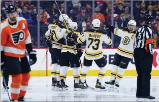  ?? MATT SLOCUM — THE ASSOCIATED PRESS ?? Bruins players celebrate after a goal by Derek Forbort during the second period against the Flyers on Saturday at the Wells Fargo Center.