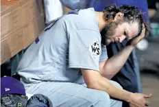  ?? JAMIE SQUIRE/GETTY IMAGES ?? Dodgers starter Clayton Kershaw sits in the dugout after exiting Game 5 of the World Series during the fifth inning, on Sunday.