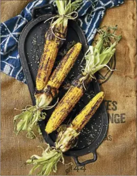  ?? PHOTO COURTESY OF MATTHEW BENSON — WORKMAN PUBLISHING ?? Grilled corn with sesame soy butter baste. minced 2 scallions (white and green parts), trimmed and finely chopped 2 tablespoon­s soy sauce ½ teaspoon freshly ground black pepper