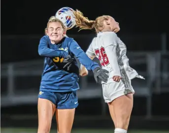  ?? For the Post-Gazette ?? Mars defender Eva Ranalli, left, battles Moon’s Eva Molnar in the PIAA Class 3A semifinals Wednesday night.