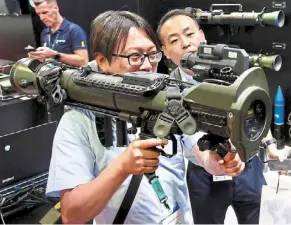  ?? — Faihan Ghani/the star ?? Cool gear: a visitor testing out military equipment at the dsa and natsec asia 2024 military exhibition at MITEC, Kuala Lumpur.