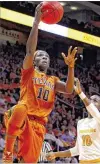  ?? WADE PAYNE / AP ?? Texas freshman guard Lashann Higgs beats Tennessee’s Meme Jackson for a layup on Sunday. Higgs led the Longhorns with 18 points.