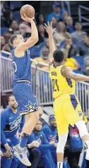  ?? JOHN RAOUX/AP ?? The Magic’s Aaron Gordon shoots over the Indiana Pacers’ Thaddeus Young on Friday night at Amway Center.