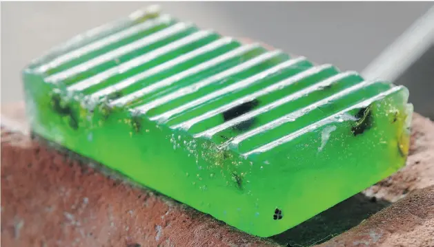  ?? Photos: Bruce Edwards, Edmonton Journal ?? This glowing green bar of soap is comprised of lettuce, sea kelp and poppy seeds, natural ingredient­s that are good for your skin.