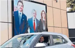  ?? KHALIL MAZRAAWI/GETTY-AFP ?? A billboard shows King Abdullah II, center, Queen Rania and their son Crown Prince Hussein. Allegation­s against the king’s half brother exposed a royal rift.