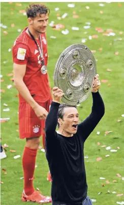  ??  ?? Persönlich­e Genugtuung: Bayern-Trainer Niko Kovac jubelt mit der Meistersch­ale. Hinten: Leon Goretzka.