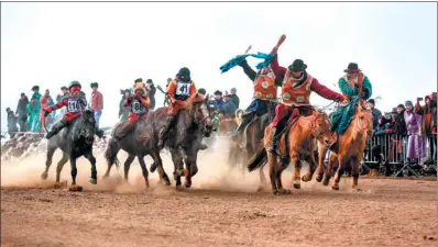  ?? BYAMBASURE­N BYAMBA-OCHIR / ?? Child jockeys compete in a spring horse race on the outskirts of Mongolian capital Ulaanbaata­r last week.