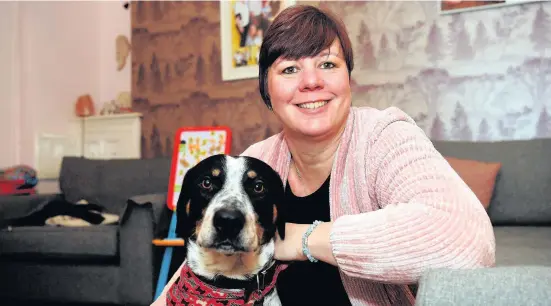  ?? Richard Williams ?? > Lindsey Thomas at home in Aberdare with Hugo, who started a fire in the kitchen on New Year’s Eve