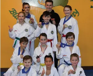  ??  ?? Young stars Master Hutton Fitness medallists show off their prizes with coach Jack Lobban