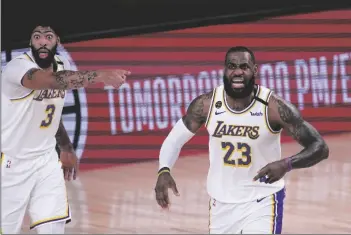  ?? ASSOCIATED PRESS ?? LOS ANGELES LAKERS’ LEBRON JAMES (right) and Anthony Davis argue a call during the first half of an NBA conference semifinal playoff game against the Houston Rockets on Saturday in Lake Buena Vista, Fla.