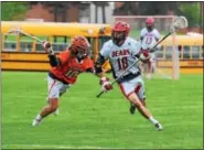  ?? AUSTIN HERTZOG - DIGITAL FIRST MEDIA ?? Perkiomen Valley’s Brian Fehr (10) dives toward Boyertown’s Dan Yednock as he crosses the midline during their PAC boys lacrosse game Thursday at Boyertown.