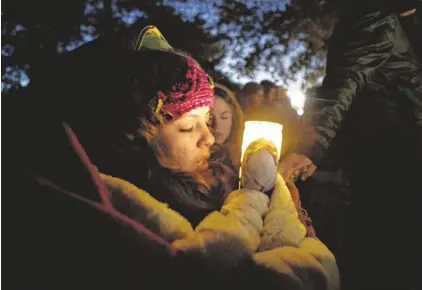  ?? PHOTOS BY NICK OZA/THE REPUBLIC ?? Arizonan Anakarina Rodriguez and other immigratio­n-reform supporters gathered in October outside the home of House Speaker John Boehner, R-Ohio, to pray for a comprehens­ive bill. Advocates still cling to the possibilit­y a bill could pass this year.