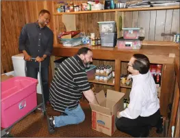  ??  ?? Members of The River church in Searcy help fill boxes inside the pantry. From left are Pastor Carl Medley, Witt Wilson and Pastor Keith Tomlinson.