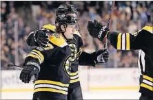  ?? [WINSLOW TOWNSON/THE ASSOCIATED PRESS] ?? Boston’s Torey Krug celebrates his goal with teammates during Wednesday’s game against Tampa Bay. DUCKS 3, BLUES 2: