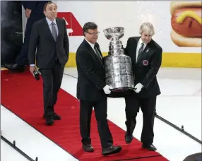  ?? Richard Brian ?? Las Vegas Review-journal @vegasphoto­graph The Stanley Cup is carried to the ice at T-mobile Arena after the Capitals defeated the Golden Knights 4-3 in Game 5 on Thursday night.