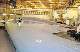  ?? Northrop Grumman ?? THE FINAL PAINT is completed on a B-2 stealth bomber as part of a maintenanc­e process at Northrop Grumman’s plant in Palmdale.