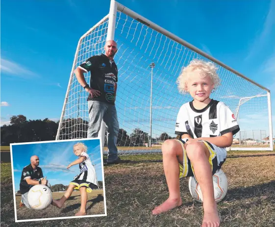  ?? Picture: JASON O’BRIEN ?? Juke Loxton, 5, with Runaway Bay Soccer Club president Lee Russell the club was awarded a $100,000 grant.