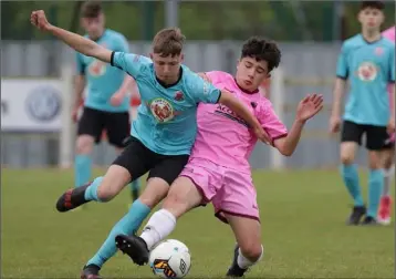  ??  ?? Darragh McGuire of Wexford F.C. stretches to win the ball ahead of Tiernan O’Brien (Cobh Ramblers).