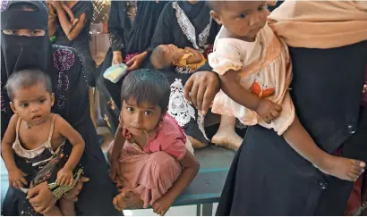  ?? AFP ?? Young Rohingya refugees waiting to be seen by a doctor at the Balukhali refugee camp in Bangladesh’s Ukhia district. —