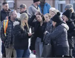  ?? RYAN REMIORZ — THE CANADIAN PRESS VIA AP ?? Parents wait for news after a bus crashed into a day care center in Laval, Quebec, on Wednesday. The driver was arrested and charged with first-degree murder.