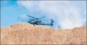  ??  ?? ■
An IAF helicopter flies over Leh in Ladakh.